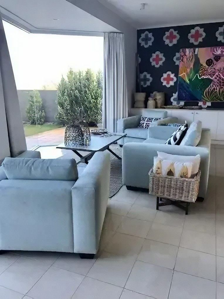 A Living Room Filled with Furniture and A Painting on The Wall — Cachia Upholstery in Tuncurry, NSW