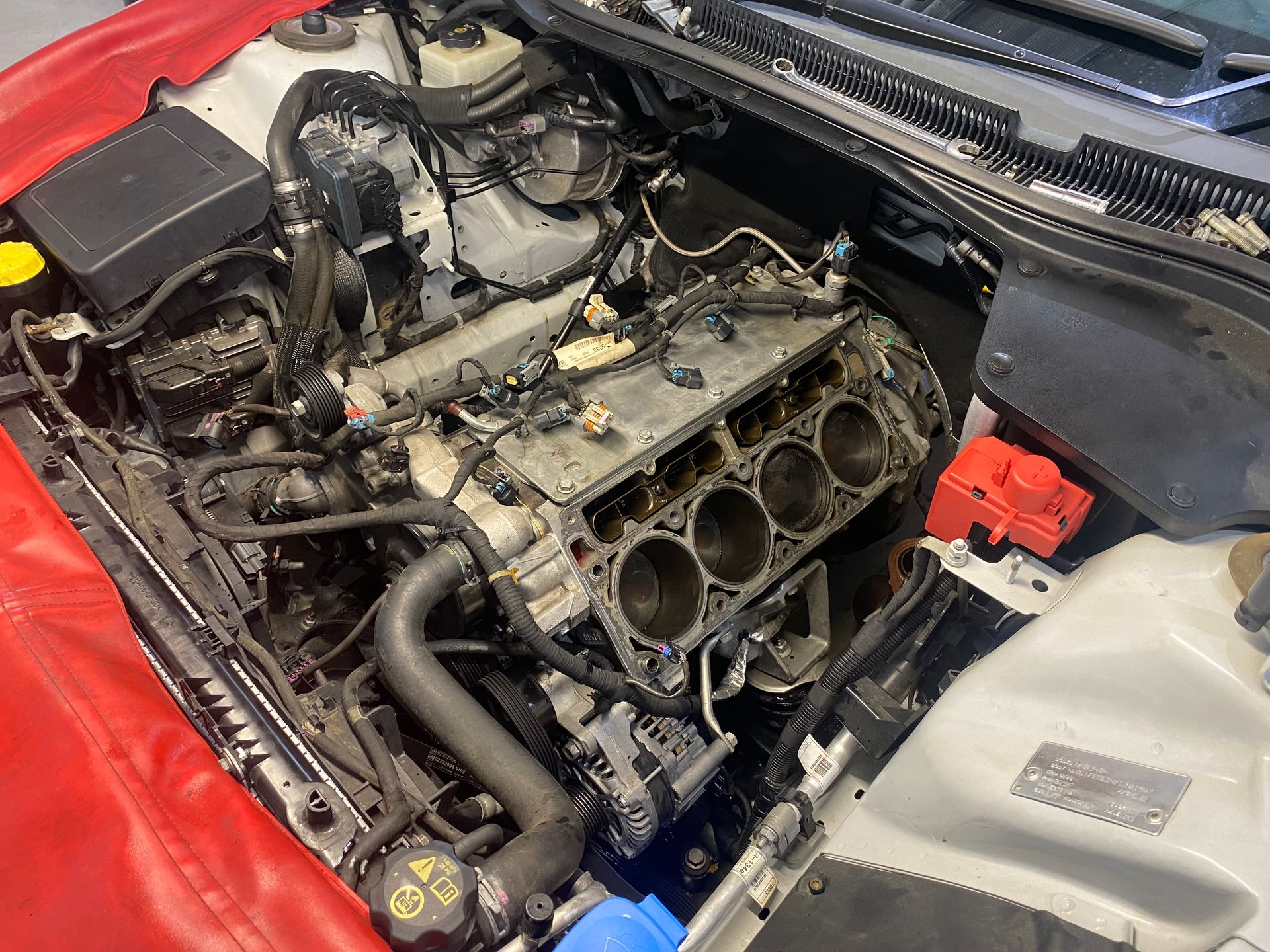 Engine of red car getting serviced — NG Mechanical Services in Thurgoona, NSW