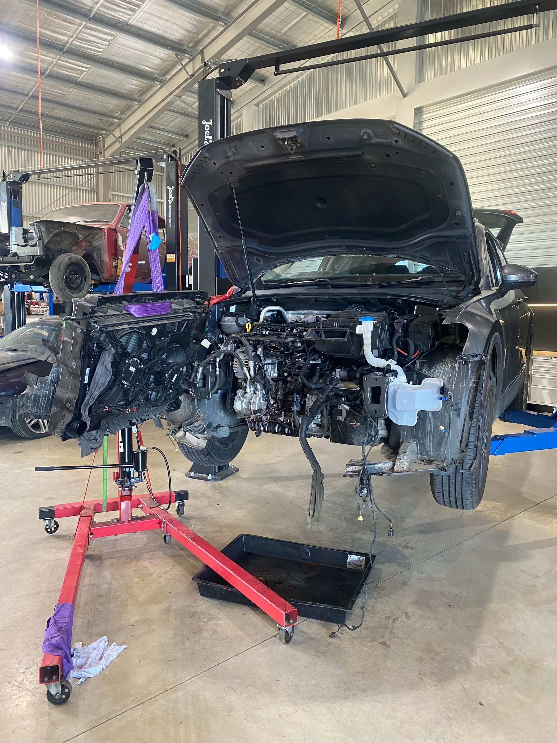 A car with the Hood up is Being Worked on in a Garage — NG Mechanical Services in Thurgoona, NSW