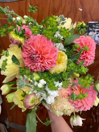 A basket filled with white flowers and pine cones