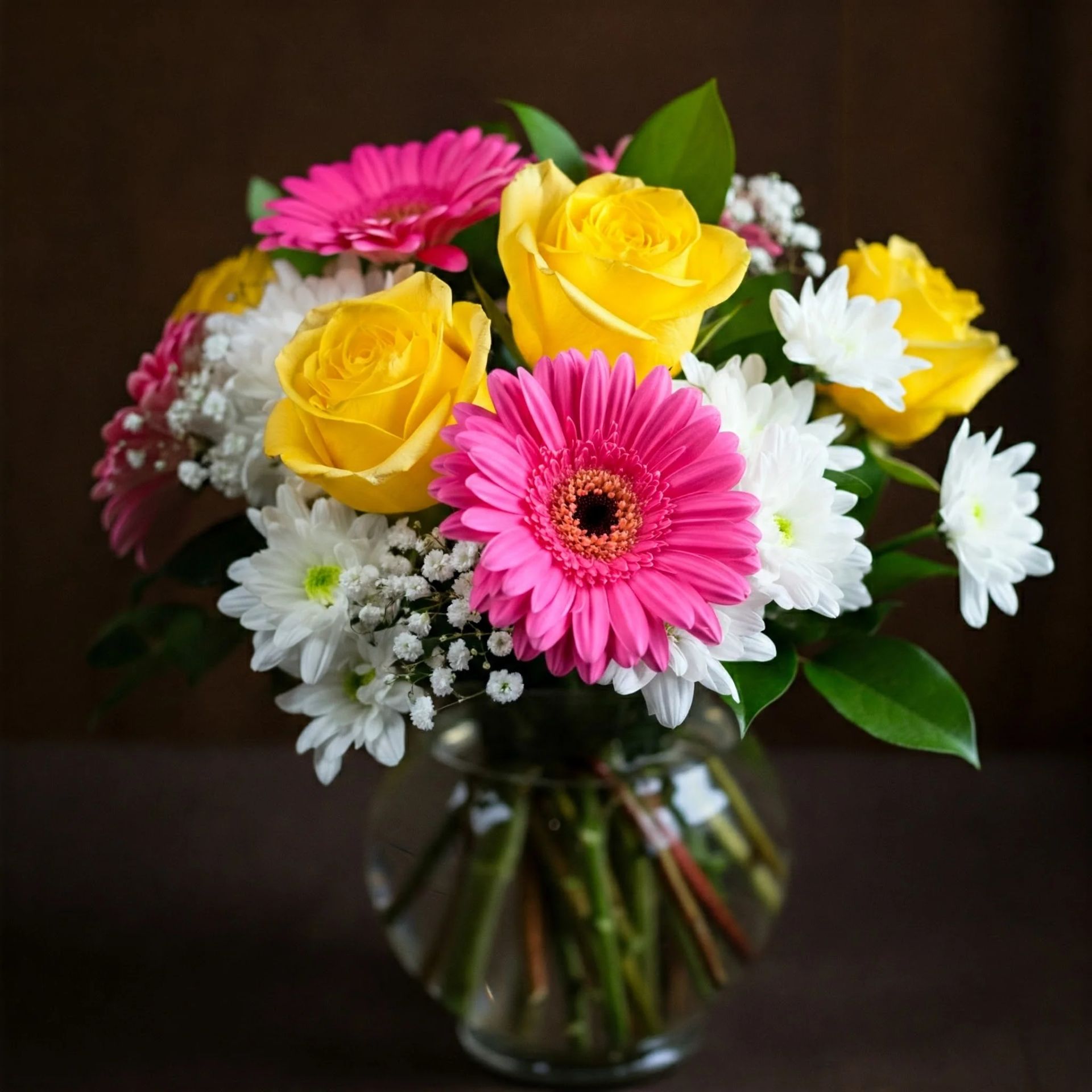 a person is holding a bouquet of pink flowers and a piece of paper