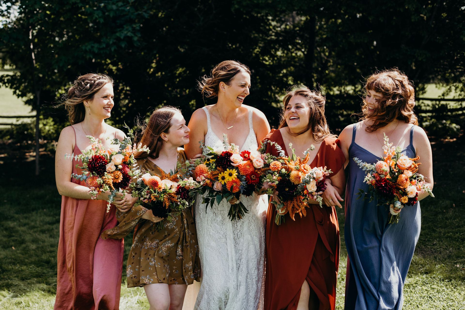 a bride and her bridesmaids holding bouquets of flowers