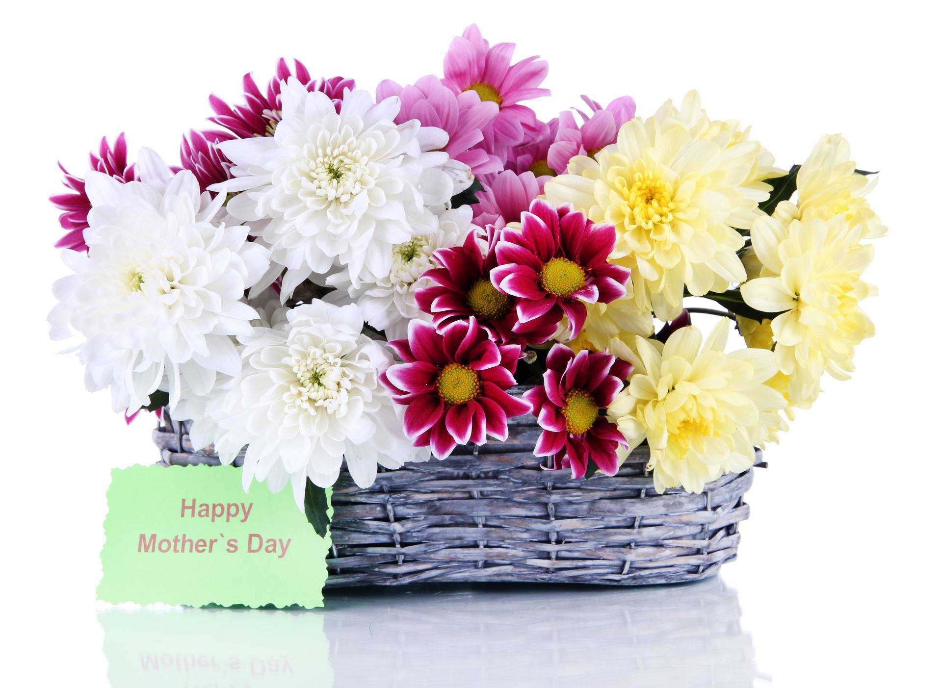 A basket of flowers with a card that says happy mother 's day
