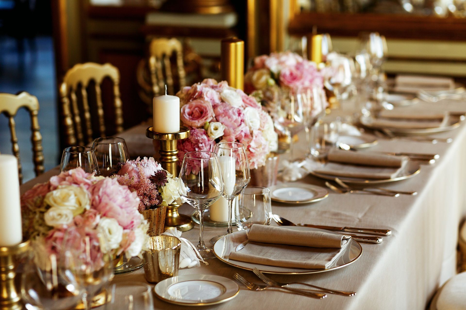 a table set for a wedding reception with flowers and candles