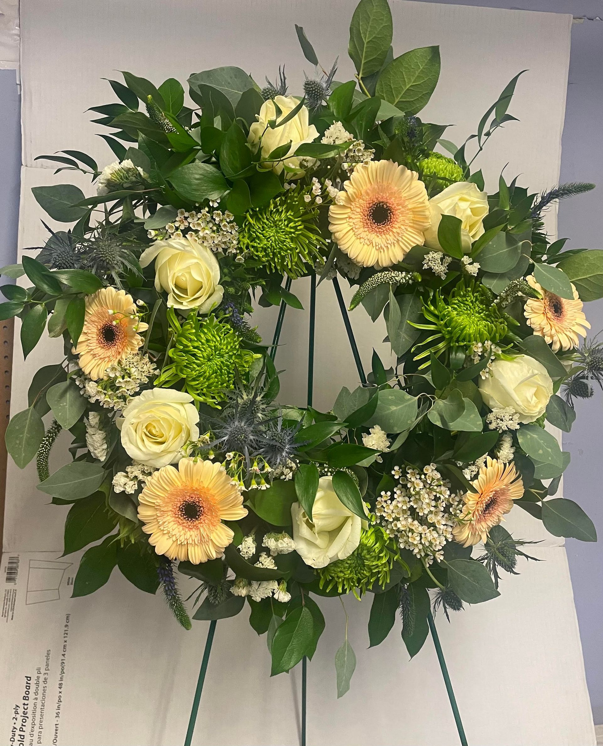 a wreath of flowers is sitting on top of a piece of paper that says project ready