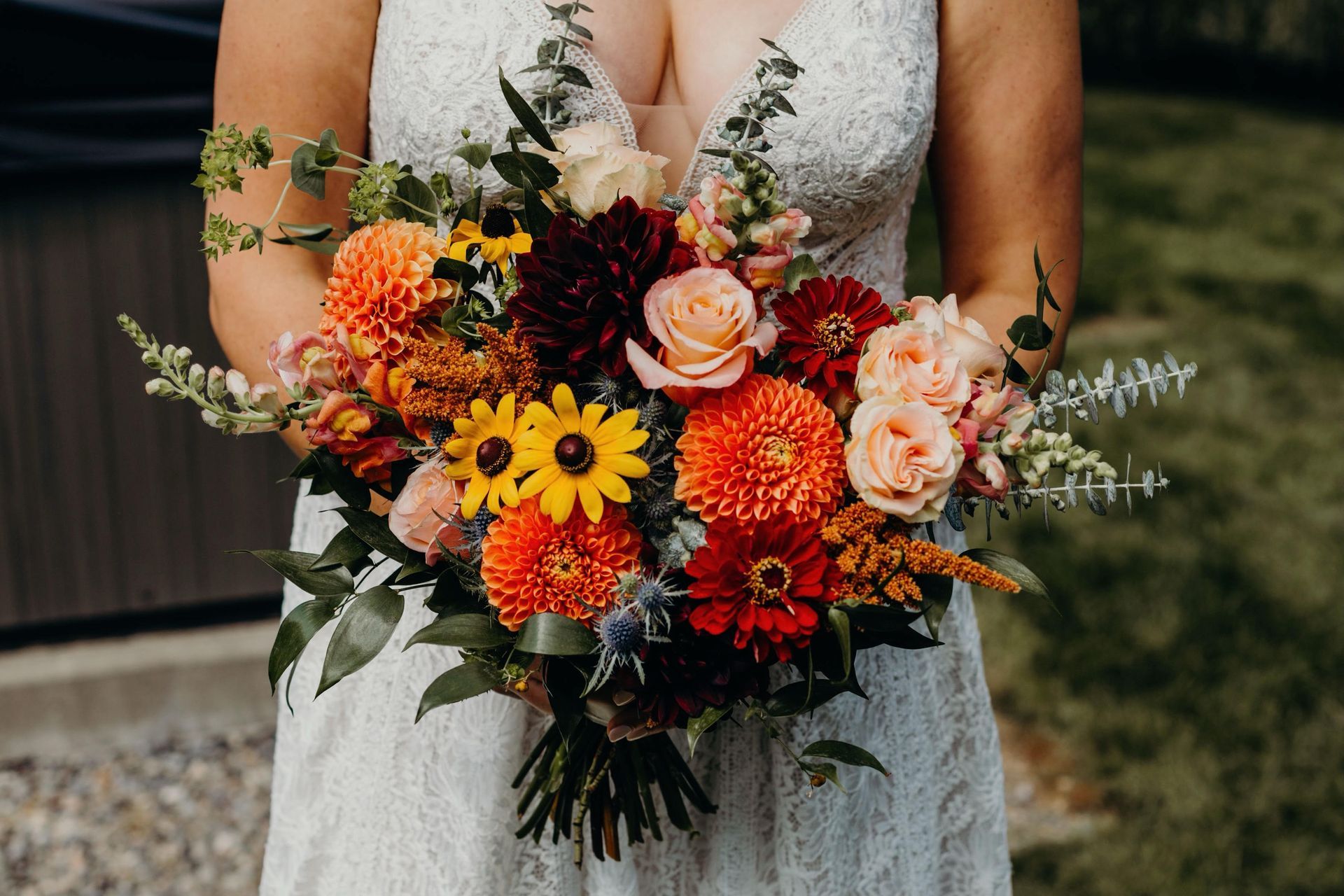 a woman in a white dress is holding a bouquet of flowers