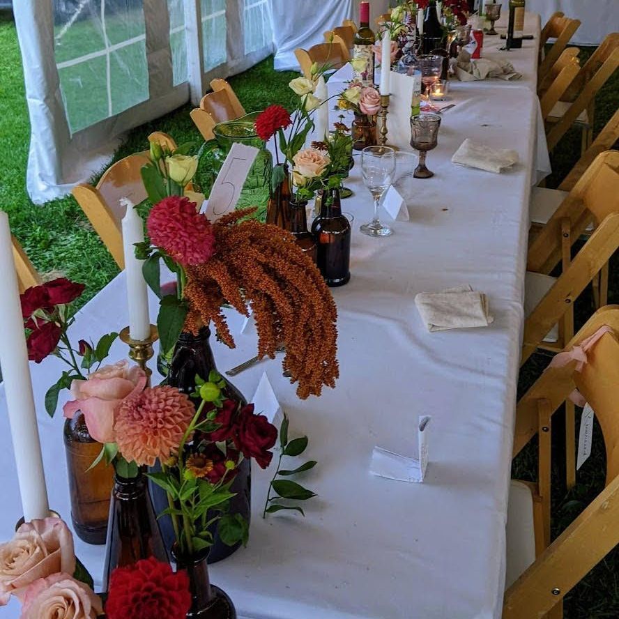 a long table with flowers and candles on it