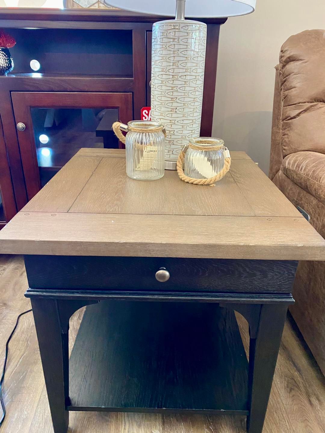 A coffee table with a lamp and candles on it in a living room.