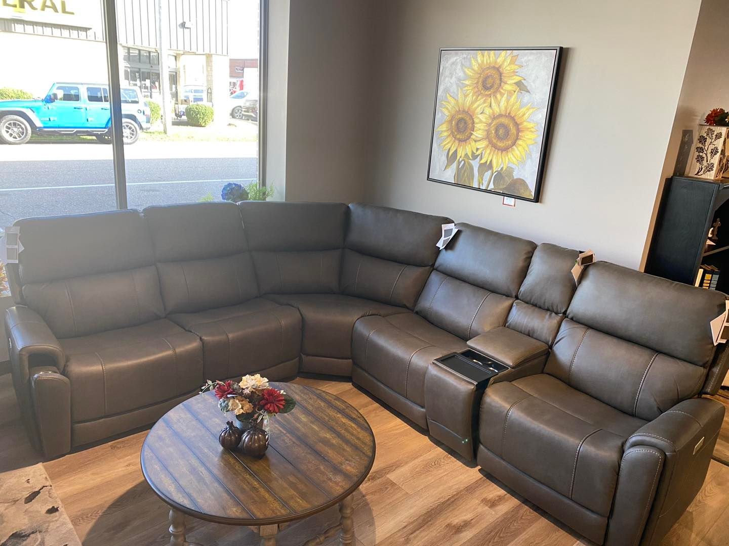 A living room with a sectional couch and a coffee table.