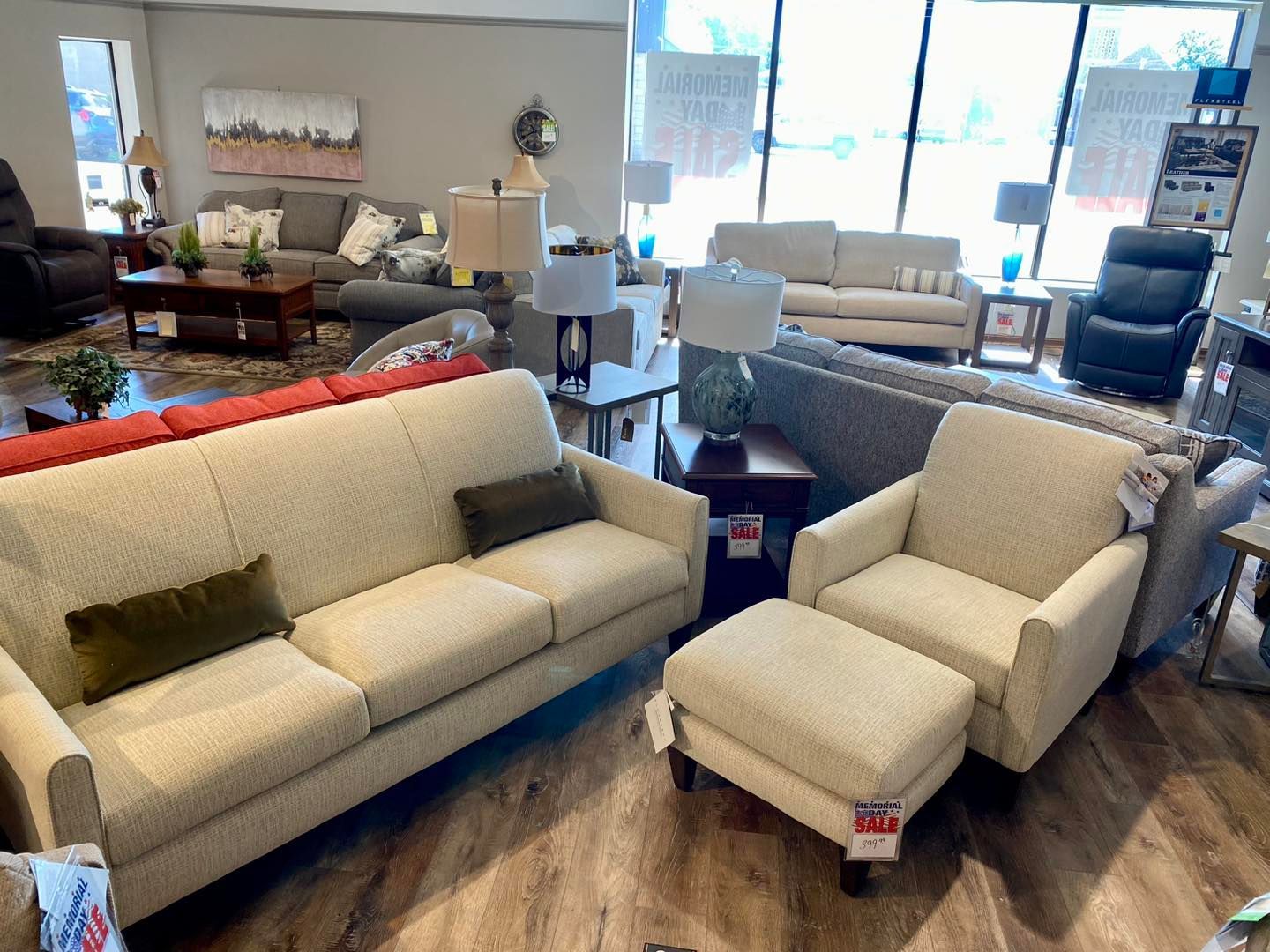 A living room filled with furniture including a couch , chair , and ottoman.
