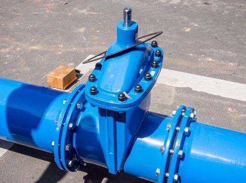 A close up of a blue pipe with a valve on it