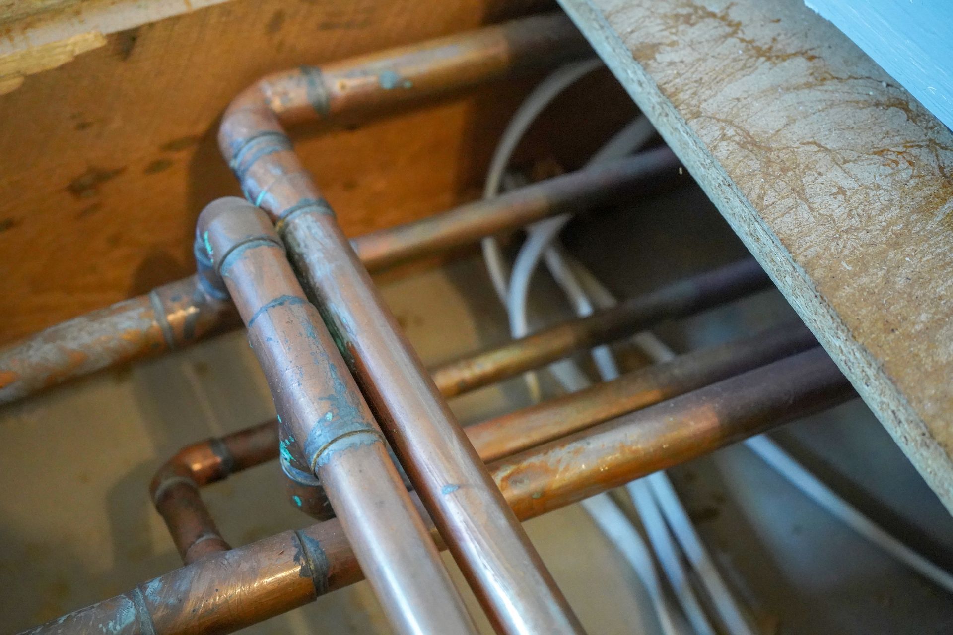 A bunch of copper pipes are connected to each other in a room.