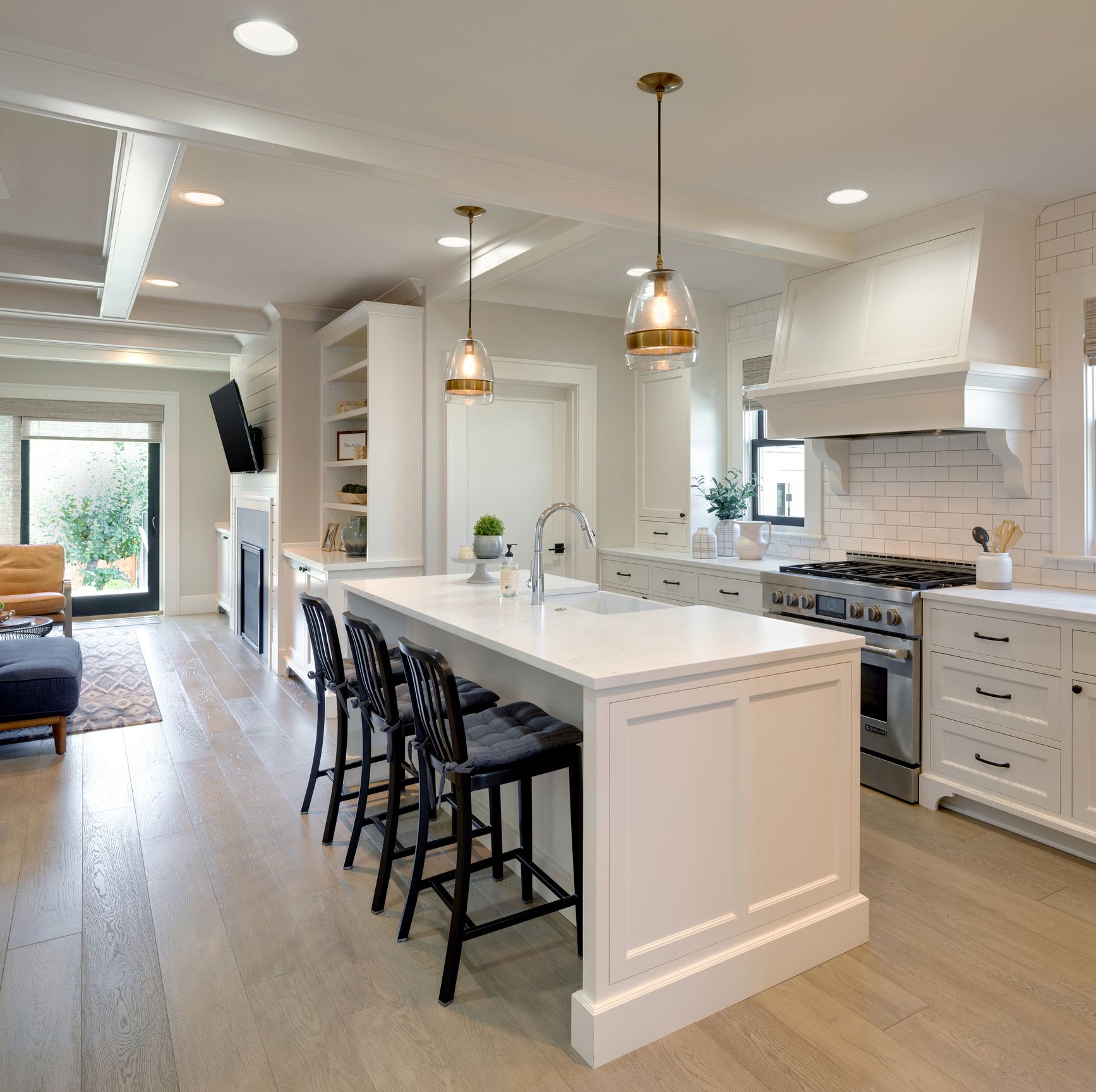 A kitchen with a large island and stools