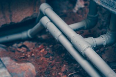 A close up of a bunch of pipes in the ground.
