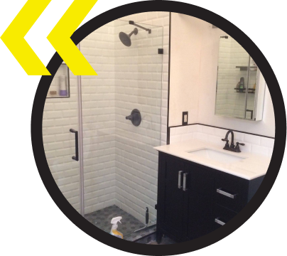 A bathroom with a sink and a walk in shower