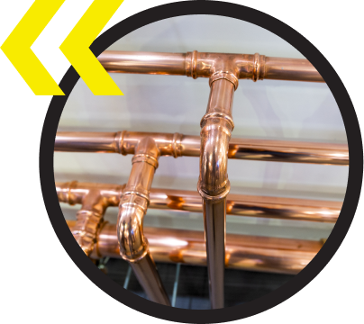 A close up of copper pipes in a circle