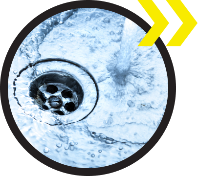 A close up of a sink drain with water coming out of it