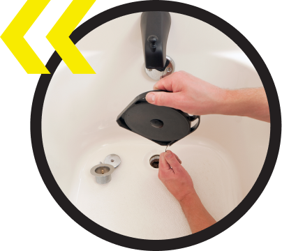 A person is fixing a faucet in a bathroom sink
