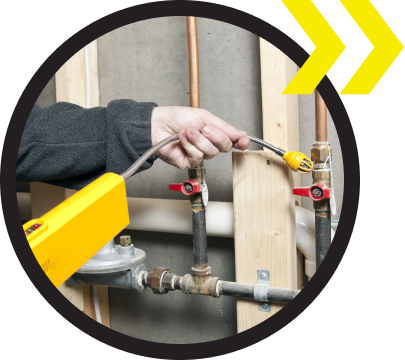 A person is working on a pipe with a yellow tool A person is working on a pipe with a yellow tool