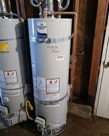 A room with a lot of pipes and a boiler on the wall.