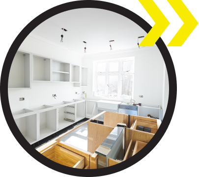 A kitchen under construction with a yellow arrow pointing to the right