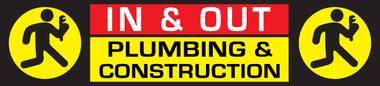 A sign that says in and out plumbing and construction
