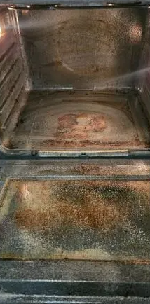 Dirty oven interior with food stains and residue.