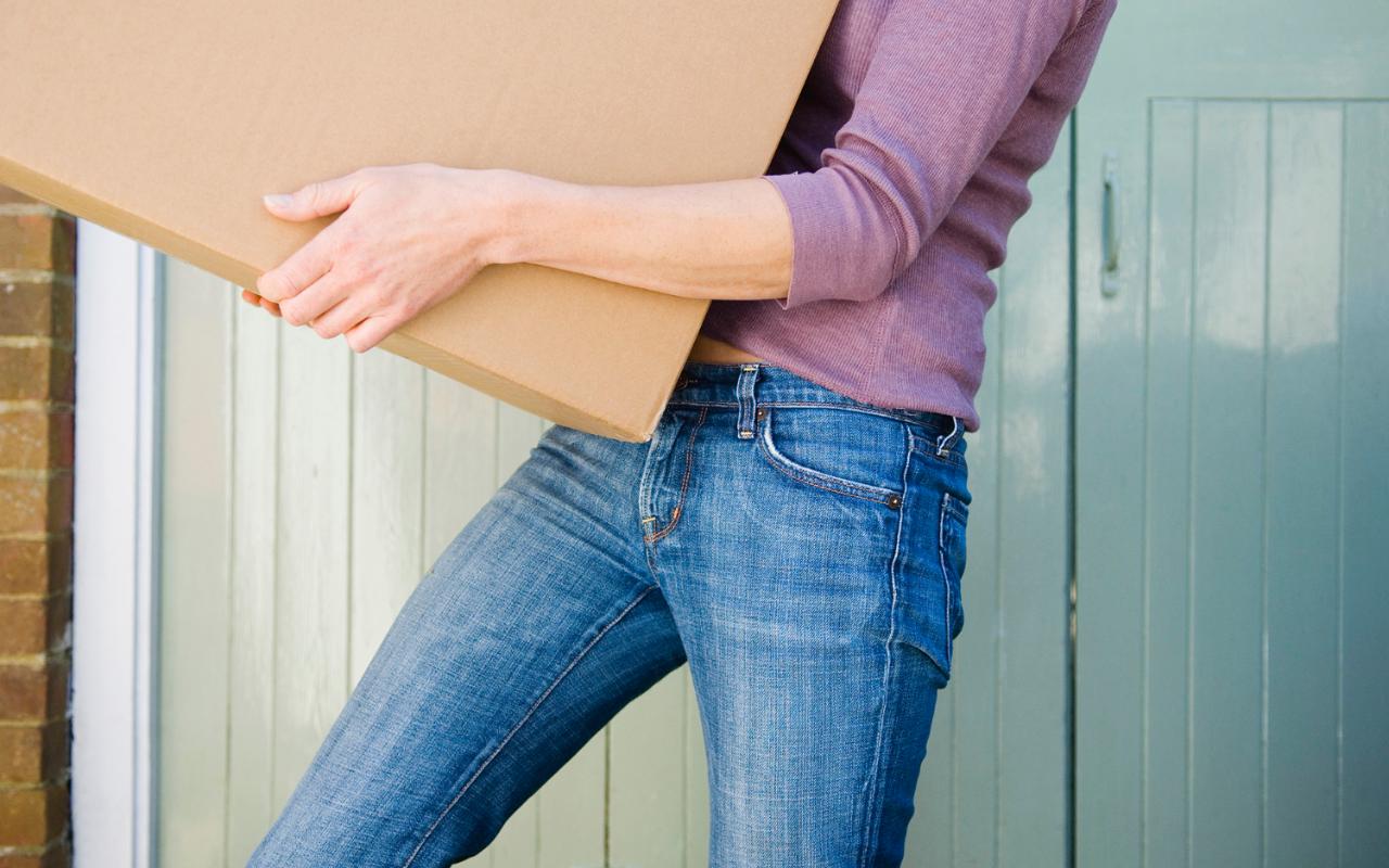 Woman carrying a moving box