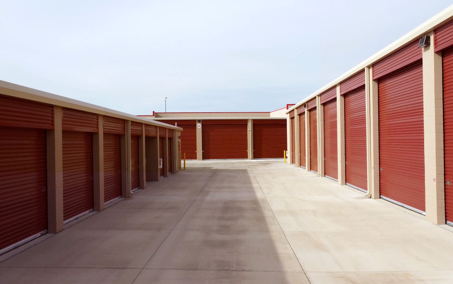 A woman is standing in front of a pile of cardboard boxes.