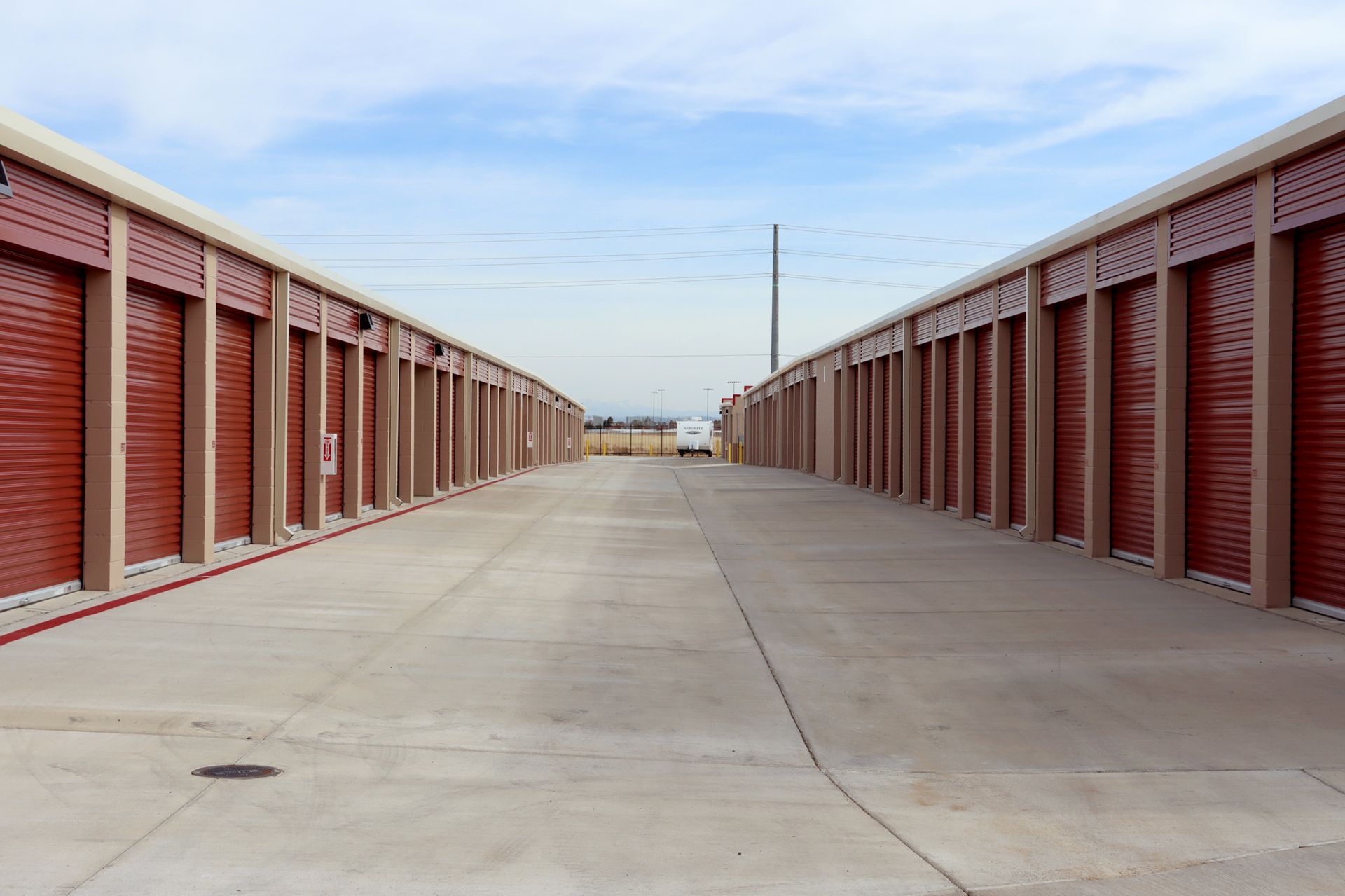 A storage garage filled with boxes and a blue door.
