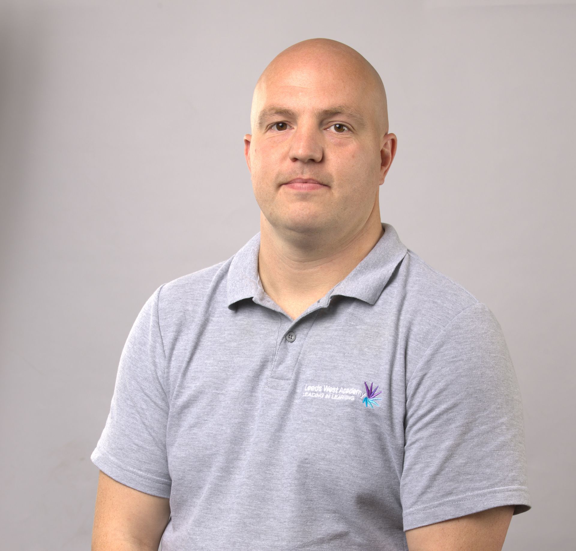 A purple icon of a person on a gray background.