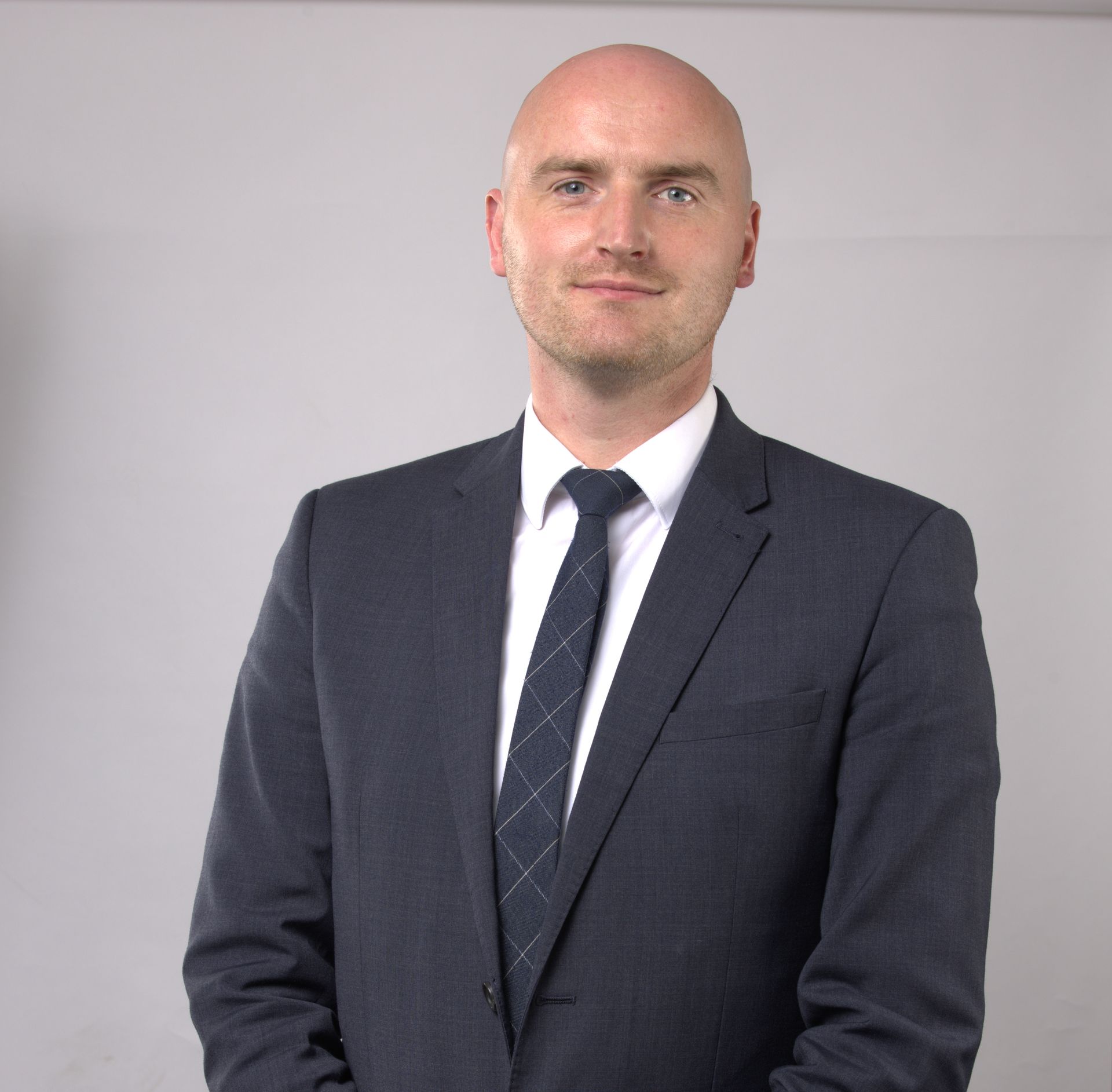 A purple icon of a person on a gray background.