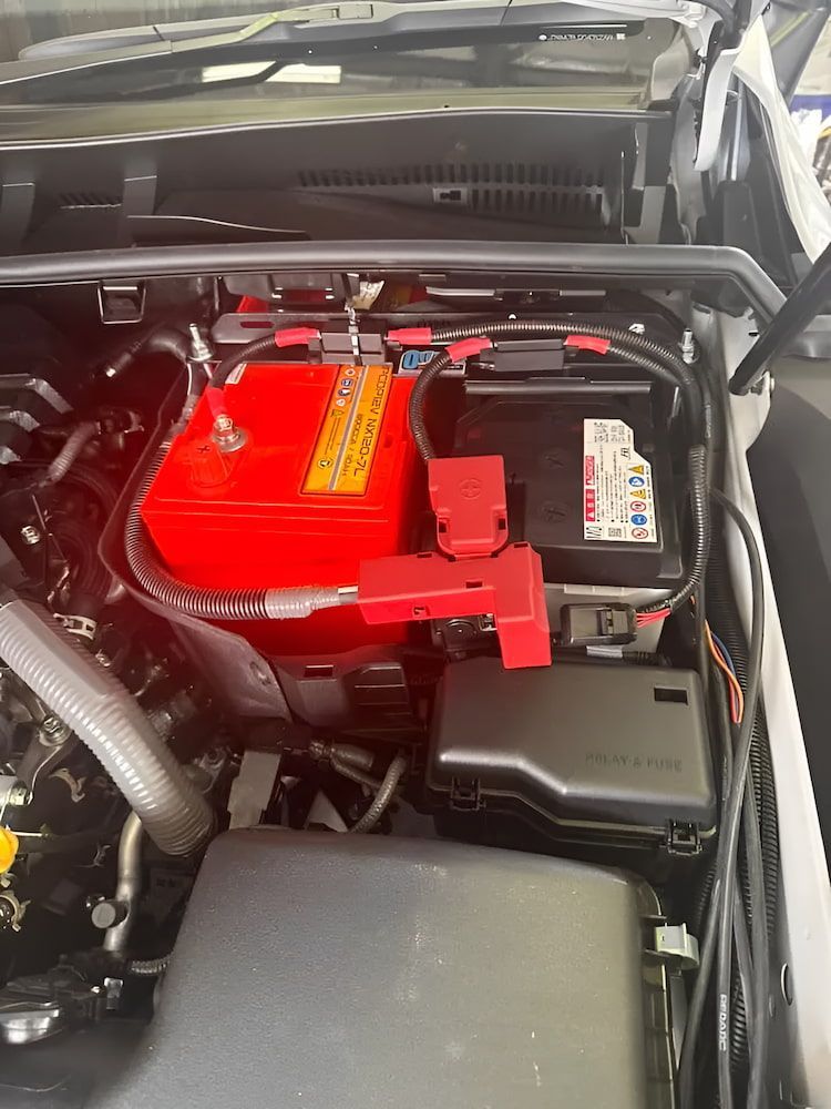 Car Engine Bay With a Red Battery and Black Battery, With Wiring — Edmonton Battery Centre in Bentley Park, QLD