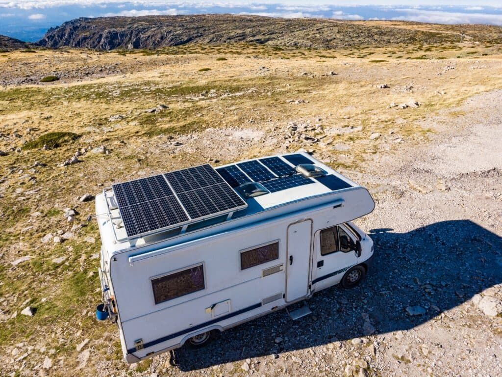 RV With Solar Panels on Its Roof Parked on a Rocky, Dry, Mountain Landscape — Edmonton Battery Centre in Bentley Park, QLD
