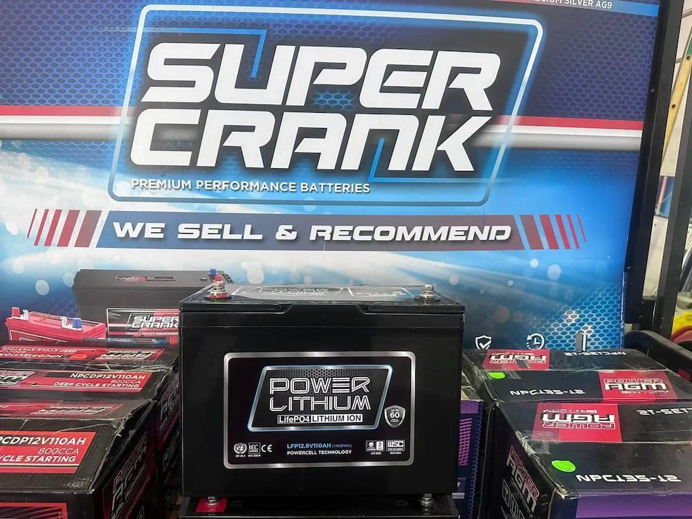 A Power Lithium Battery Displayed in Front of a Super Crank Promotional Banner — Edmonton Battery Centre in Bentley Park, QLD