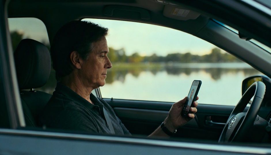 Cleveland client sitting calmly in a parked car attending a virtual session on their phone