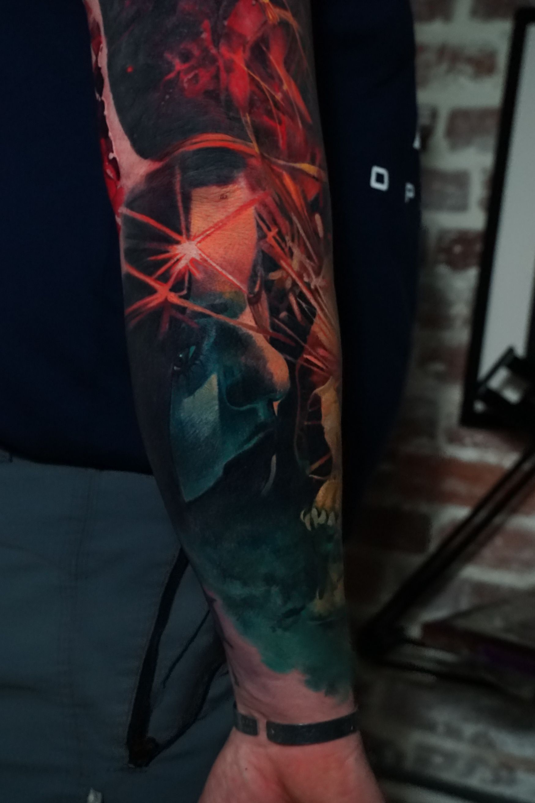 A man has a colorful tattoo on his arm.