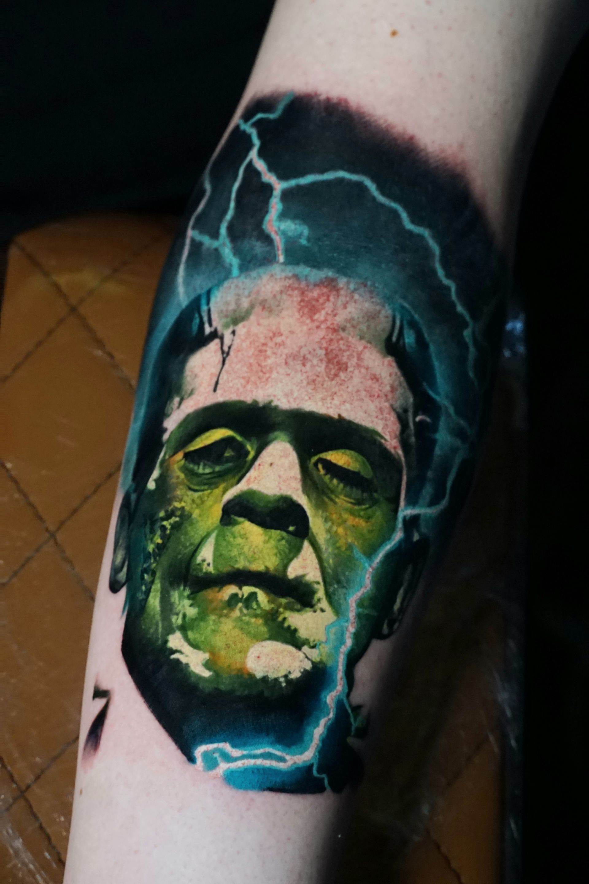 A person has a tattoo of frankenstein on their arm