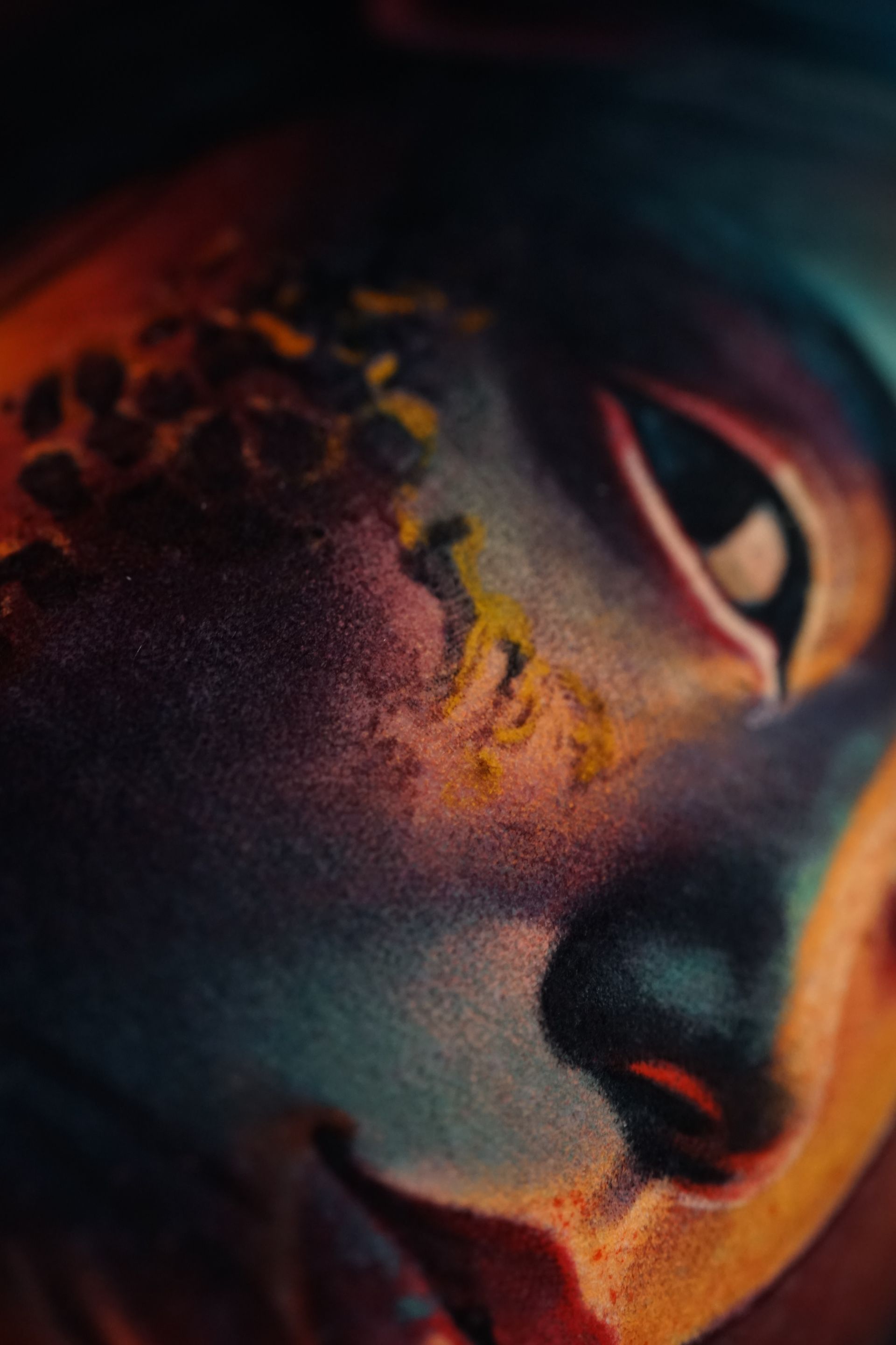 It is a close up of a painting of a person 's face.