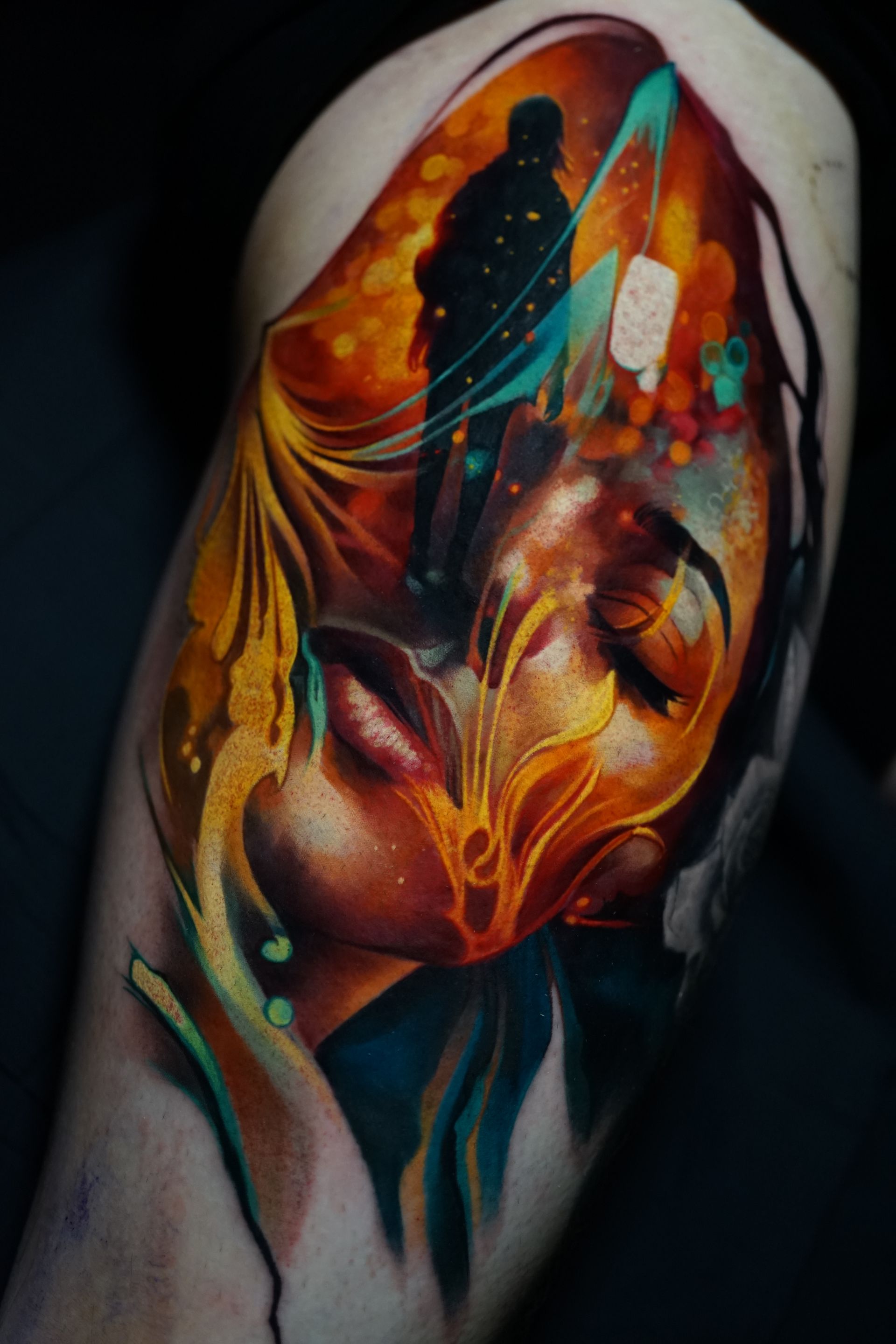A colorful tattoo of a woman 's face with a man standing behind her.
