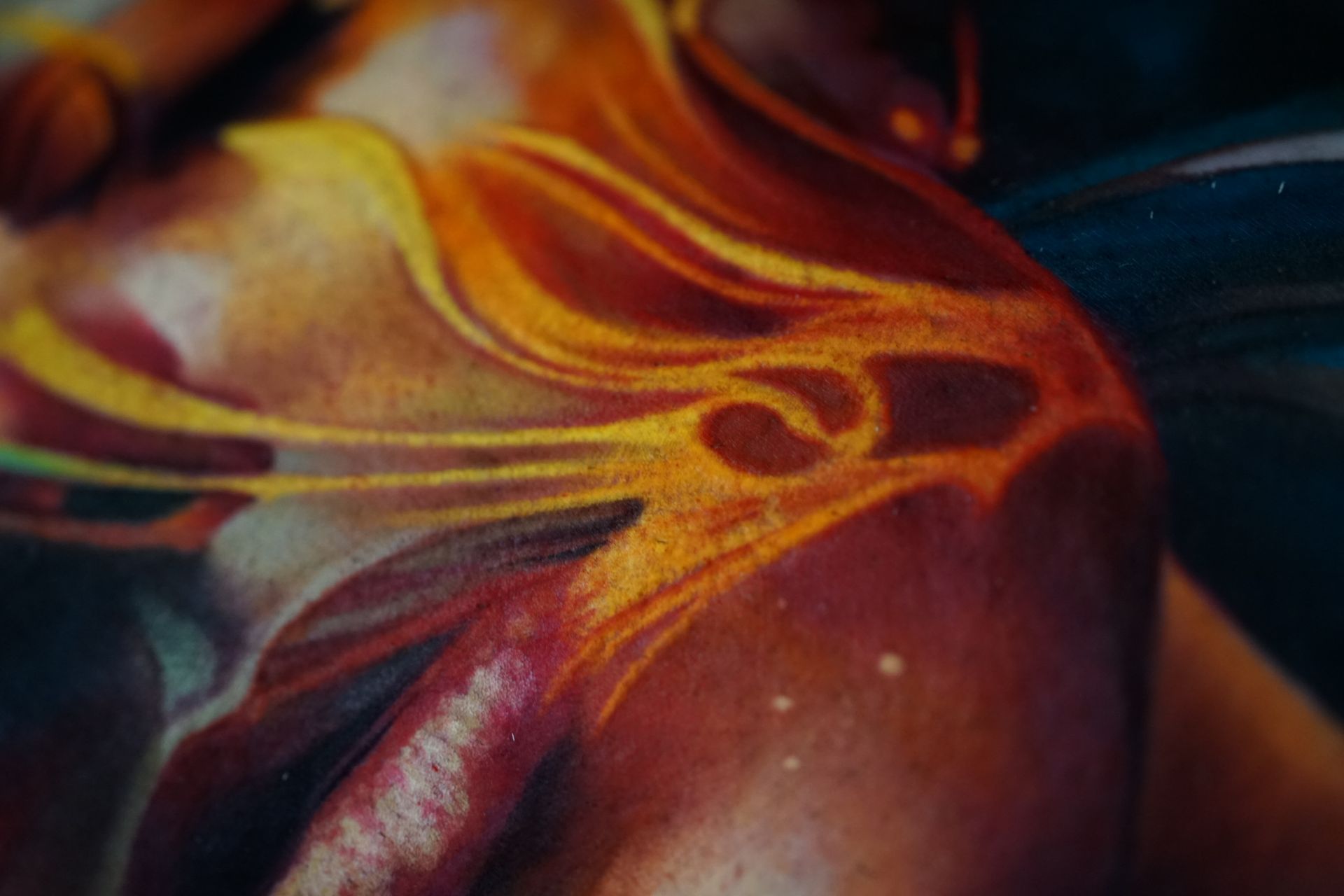 A close up of a painting of a woman 's face and shoulder