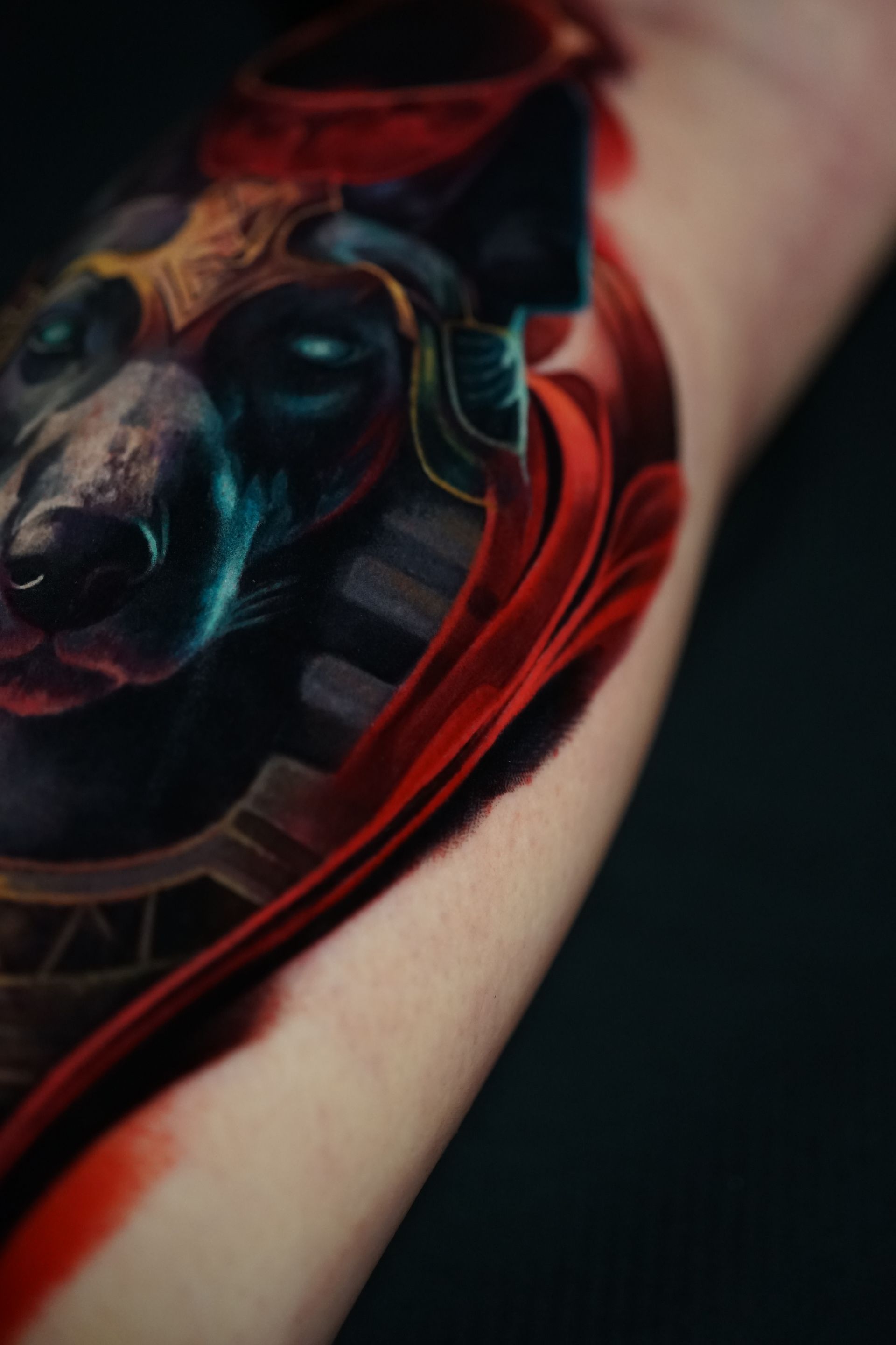 A close up of a tattoo of a wolf on a person 's arm.