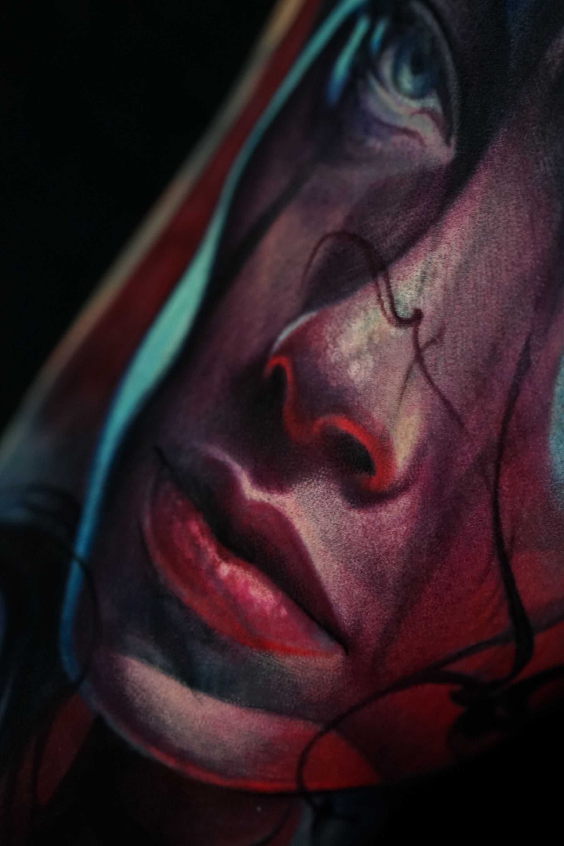 A close up of a painting of a woman 's face