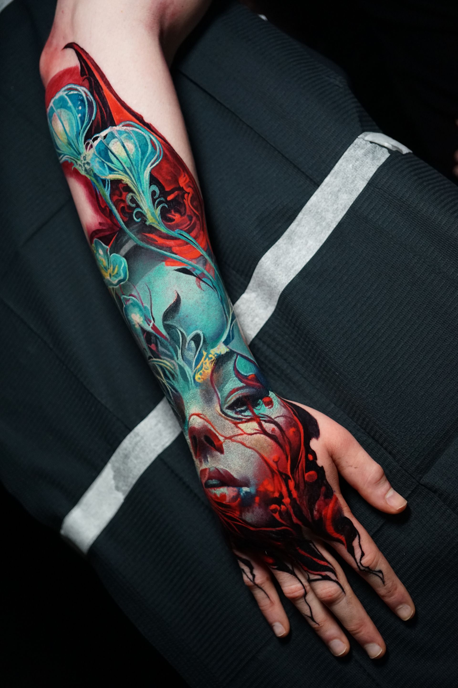 A person with a colorful tattoo on their arm
