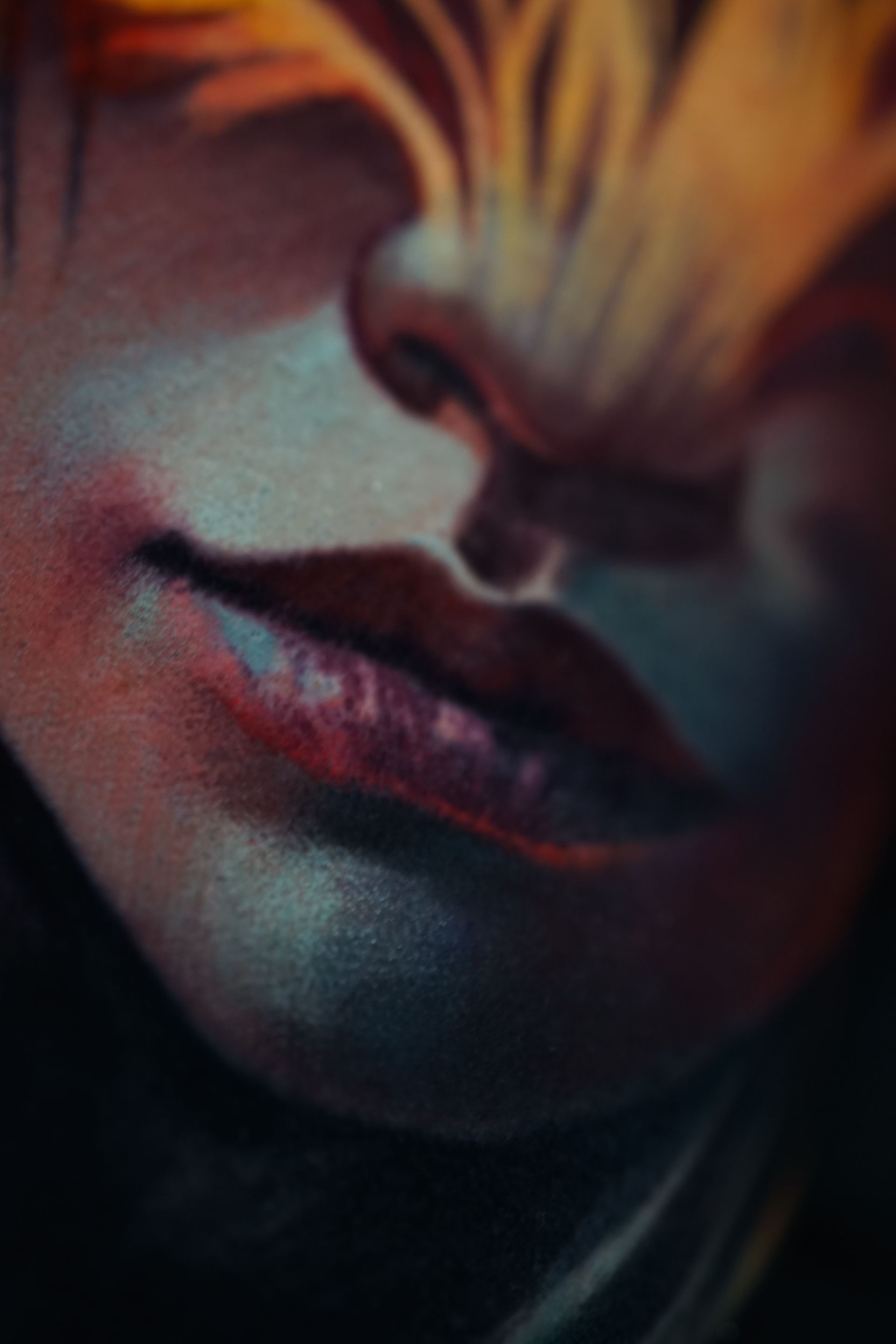 A close up of a woman 's face with a flower in her eyes.