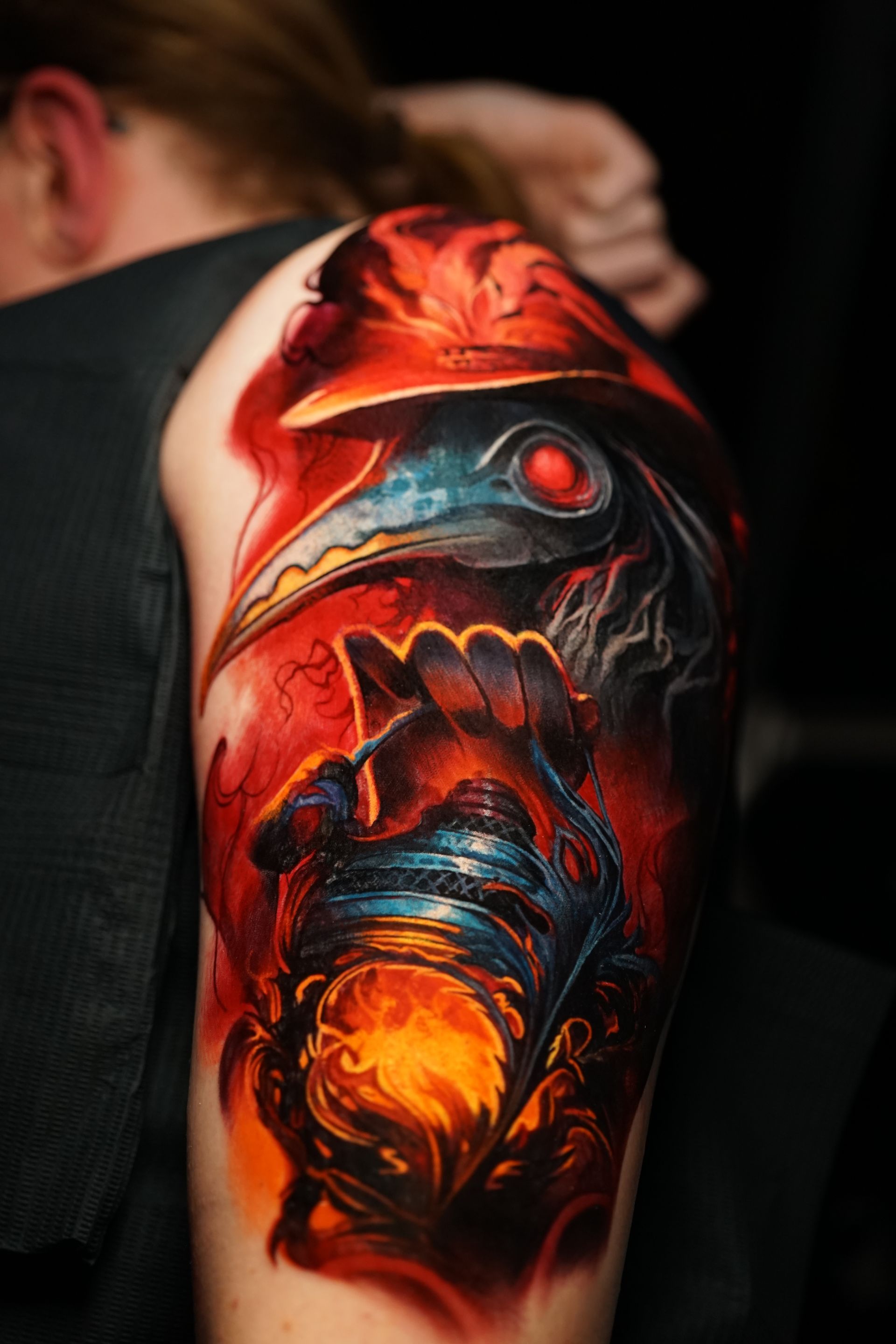 A man has a tattoo of a plague doctor on his arm.