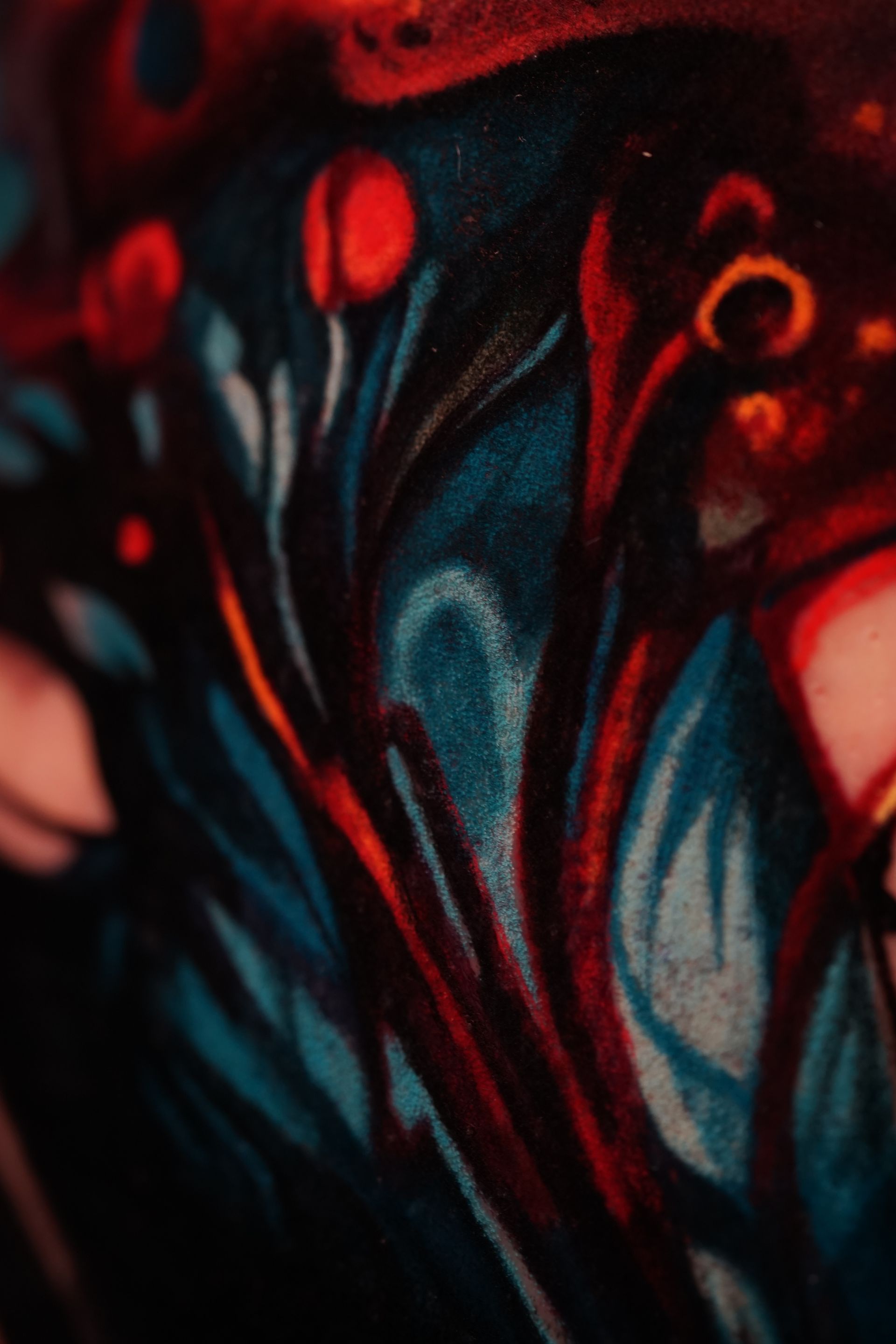 A close up of a colorful painting on a wall.