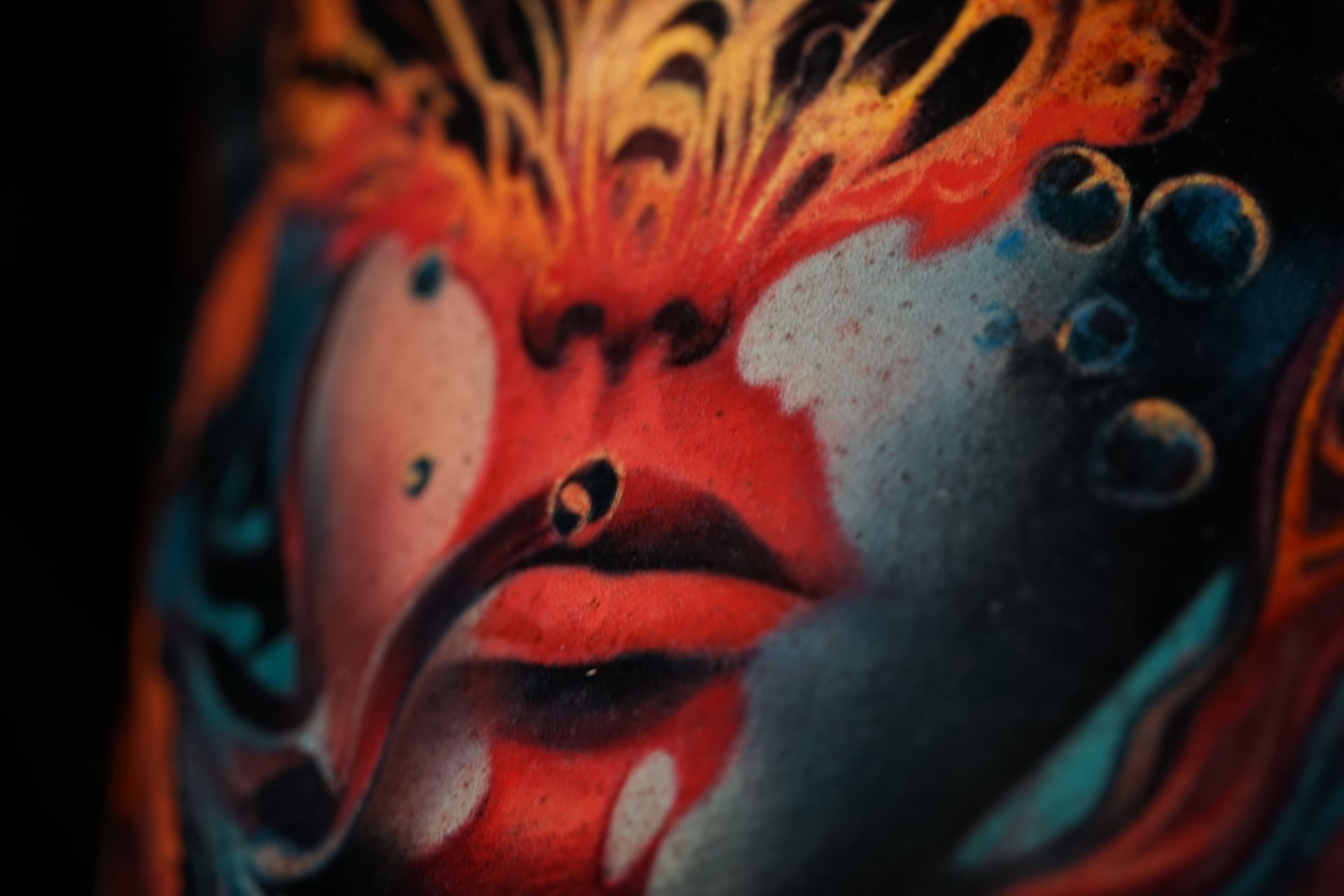 A close up of a colorful painting of a woman 's face.