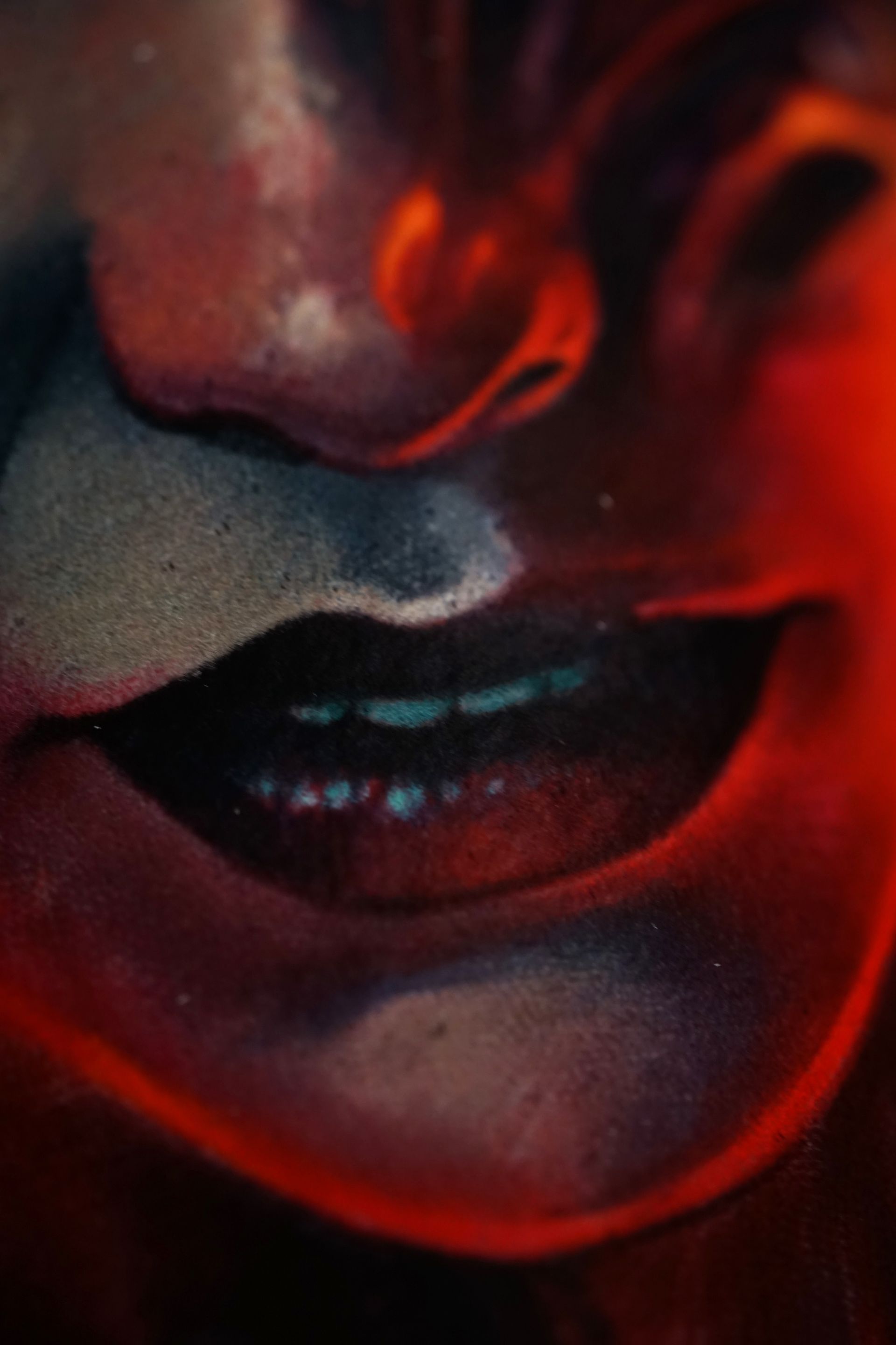 A close up of a person 's mouth with red lips and teeth.