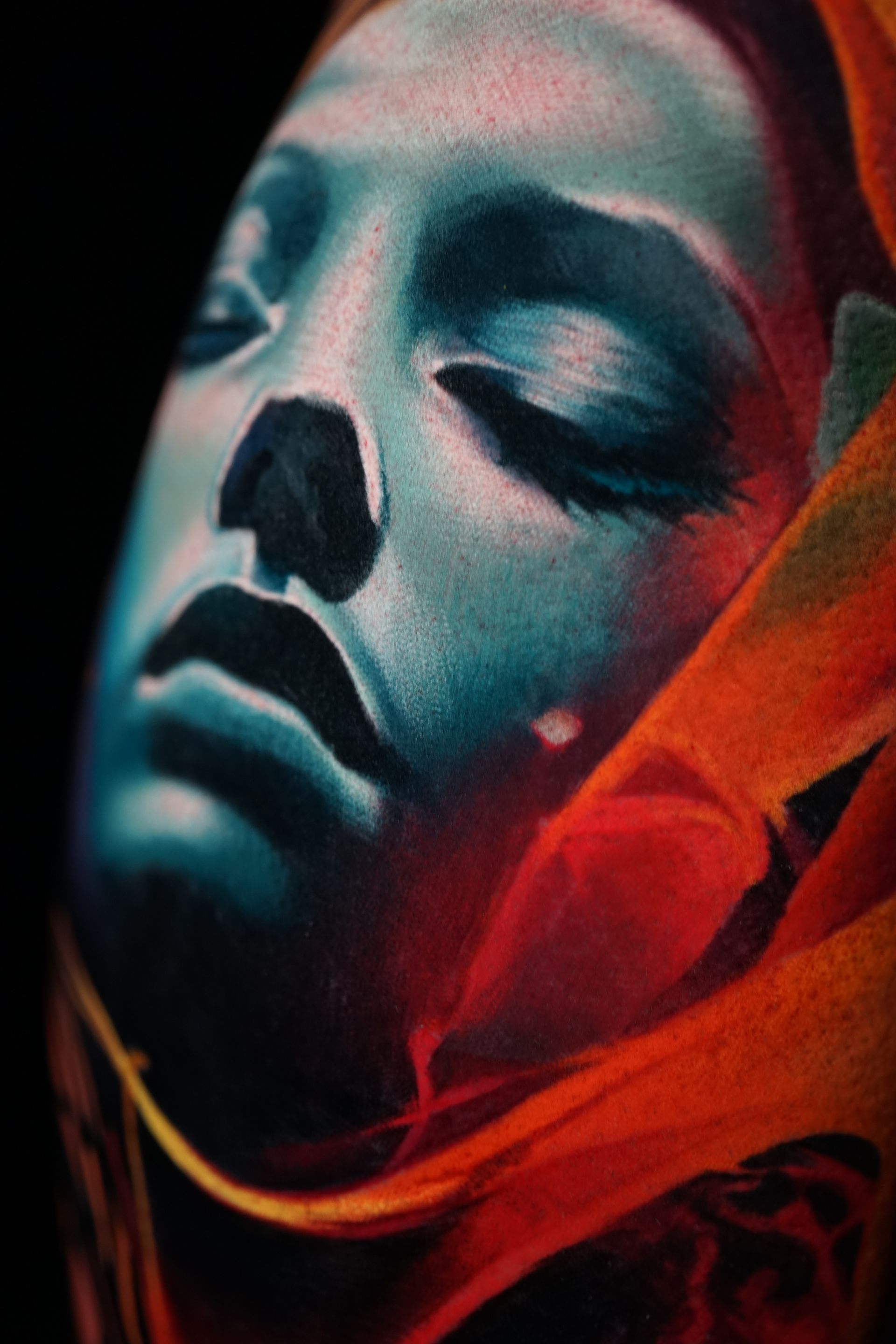 A close up of a woman 's face with her eyes closed.